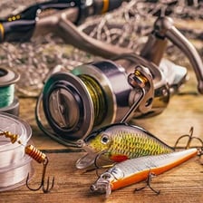 A colorful fishing lure beside a fishing rod.