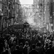 A crowded scene showing people bustling about in a busy environment.