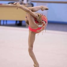 A flexible gymnast performing a graceful stretch