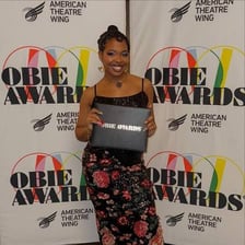 A theater award trophy associated with the Obie Awards.