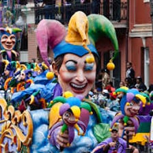 Colorful floats moving through a New Orleans Mardi Gras parade.