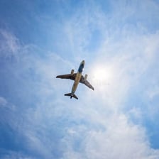 A passenger jet flying against a blue sky