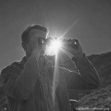 A person looking closely at a scene.