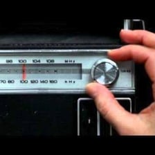 A vintage radio being tuned through static