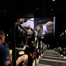 A theatergoer whose view is blocked by someone in front