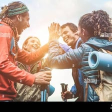Friends standing together with arms around one another