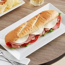 A long hoagie sandwich filled with sliced meat and toppings.