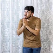 A person pleading with clasped hands