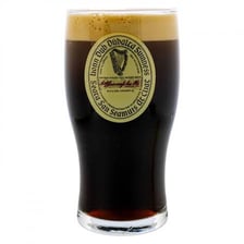 A pint glass filled with Guinness stout