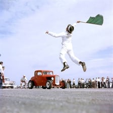 A brightly customized hot rod at a drag-racing event