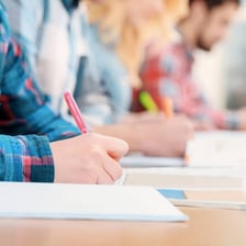 Student writing notes during a class