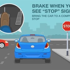 A car slowing to a stop at a road marking.