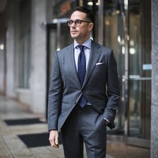 A person wearing a formal business suit and tie