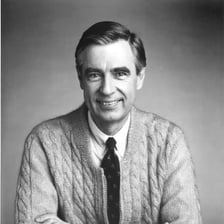 Fred Rogers wearing his familiar cardigan sweater