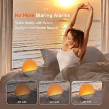 An alarm clock beside a bright sunrise scene