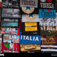 A rack of colorful tourist T-shirts in a souvenir shop