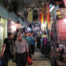 Shoppers browsing stalls in a traditional souk.