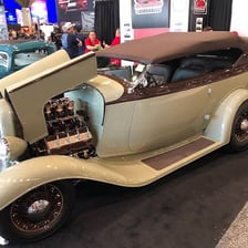 A classic convertible automobile with its soft roof lowered