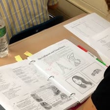 Student consulting notes during an exam.