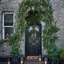 A doorway decorated with a garland.