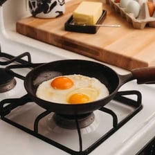 A cooking pan sitting on a stovetop burner.