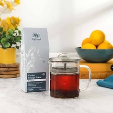 A cup of black tea made from orange pekoe leaves.