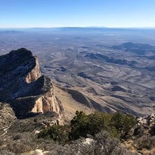 A mountain summit representing the highest point or acme.