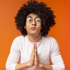 A person holding their hands together in a pleading or prayer-like gesture.