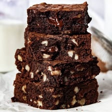 Chocolate brownies topped or studded with walnut pieces.