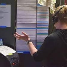 A theater stage manager monitoring a performance backstage.