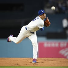 A baseball pitcher delivering a pitch during a game