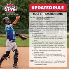 A softball pitcher delivering a high-arc pitch in a slo-pitch game.