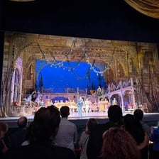 An actor turning toward the audience to deliver a brief aside.