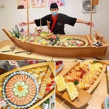 An assortment of sushi arranged on a boat-shaped platter.