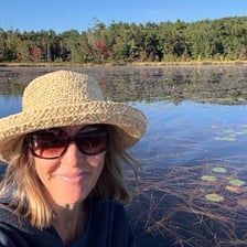 A person taking a selfie beside a marsh
