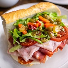 A hoagie, or submarine sandwich, filled with meats and vegetables