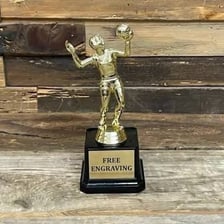 Athlete holding a Most Valuable Player trophy