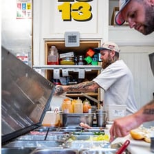 A neighborhood deli counter with sandwiches and prepared foods.