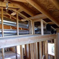 Metal ventilation ducts carrying air through a building