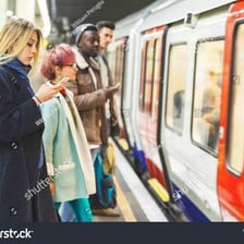A person waiting expectantly at a train station.