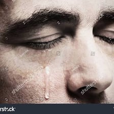 A person visibly crying with tears.
