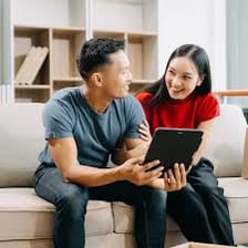 Two people standing together outside a home they share