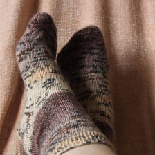 The toe end of a knitted sock
