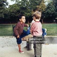 Children having an animated argument on a school playground