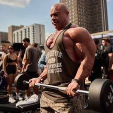 Person performing biceps curls with a barbell.