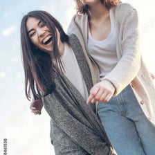 Two friends smiling and laughing together