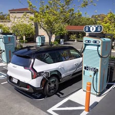 Electric cars plugged into charging stations.