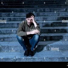 A person sitting with a visibly tense posture