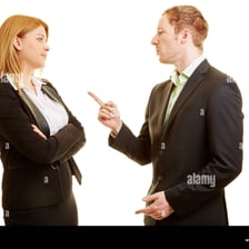 Two people facing each other while expressing disagreement.