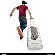A person hurriedly leaving with a suitcase